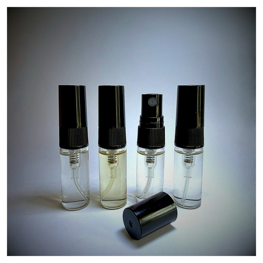 J'essence Parfums Discovery Quartet extrait de parfum. Four clear 3ml spray bottles on white vignette background.